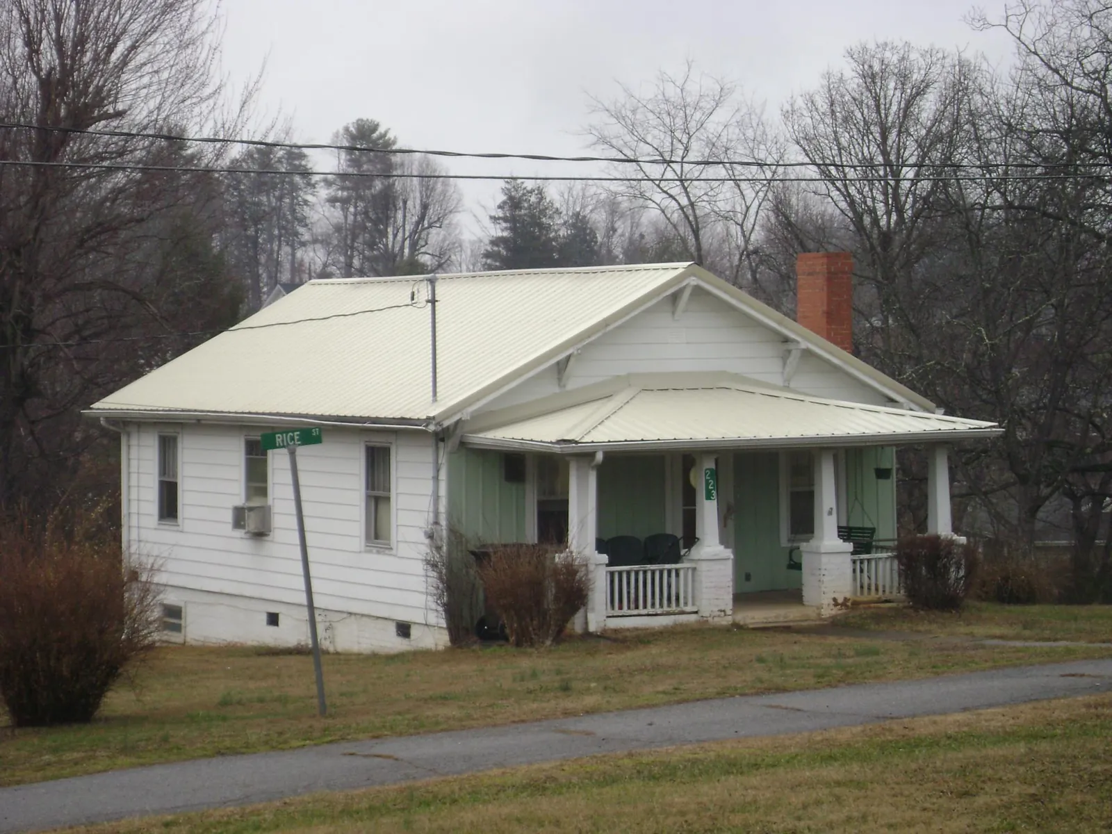 White metal roof on a craftsman bungalow at a street corner in Fayette